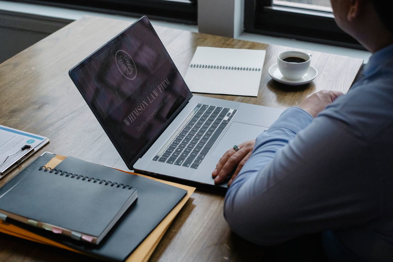 Crafting Captivating Headlines: Your awesome post title goes here From above of crop anonymous businessman using netbook while sitting at table with documents and cup of hot coffee